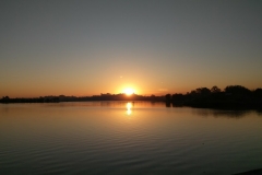 Sunrise over the lake covered on the Bike Tour